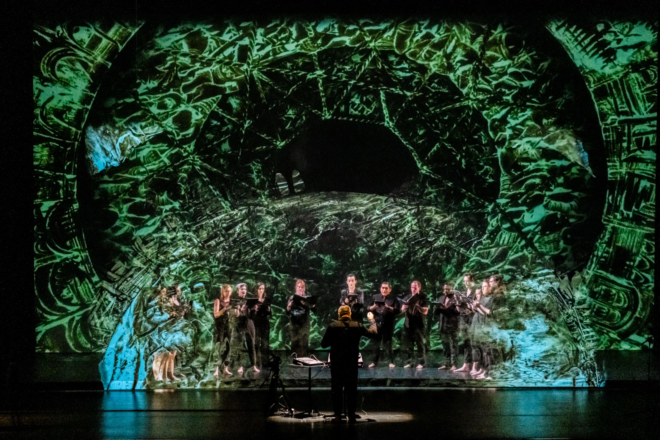 Verdigris Ensemble performing before green immersive projections