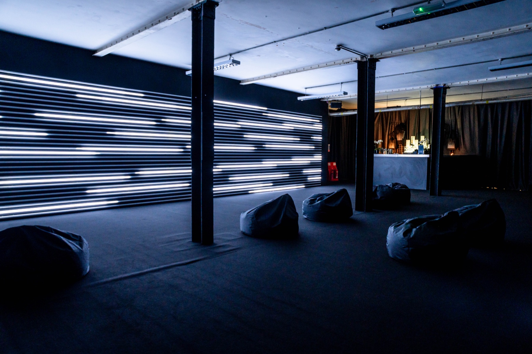 ECLIPSE by NONOTAK room with horizontal light installation and visitor seating
