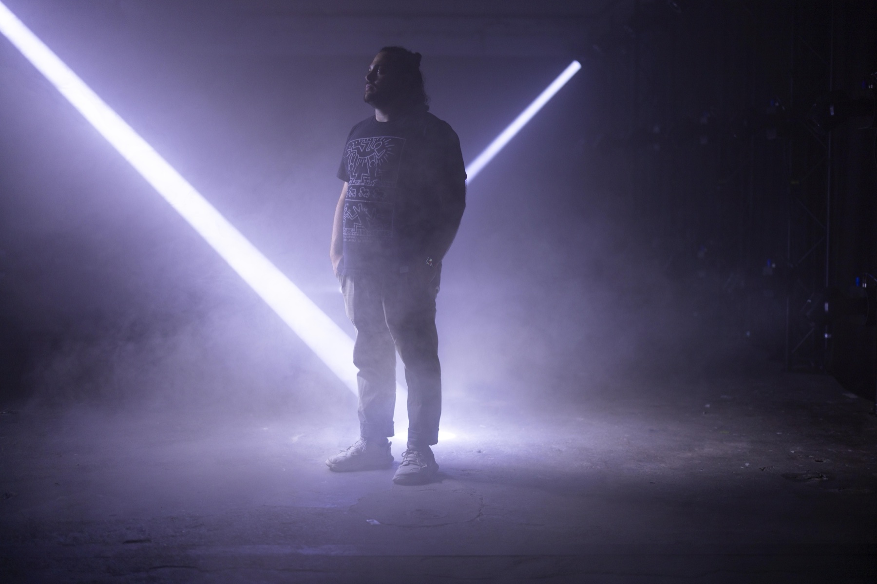 Sam standing inside ECLIPSE by NONOTAK with diagonal beams of light